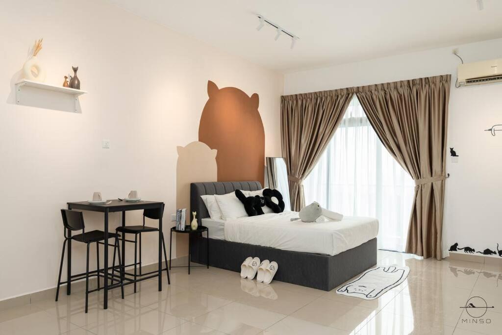 a bedroom with a bed and a table and a desk at [Cats Design Studio] #Level 27 #Austin #New condo in Johor Bahru