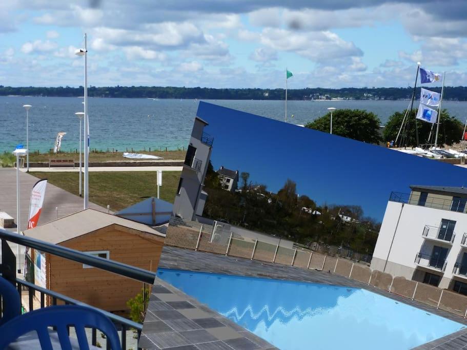 a view of the water from the balcony of a building at Au gré des Vagues, vue mer, wifi, piscine chauffée in Concarneau