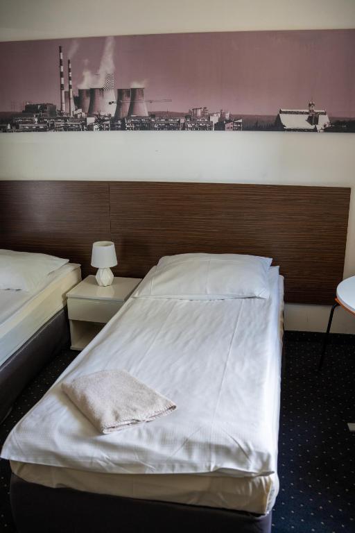 Postel nebo postele na pokoji v ubytování Aparthotel Strefa Budget