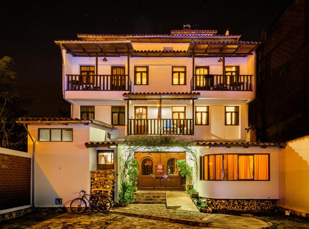 a house with a bike parked in front of it at Hotel Santa Cruz in Huaraz