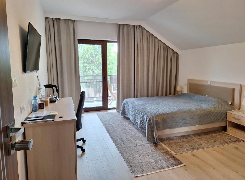 een hotelkamer met een bed, een bureau en een raam bij TREND in Arad