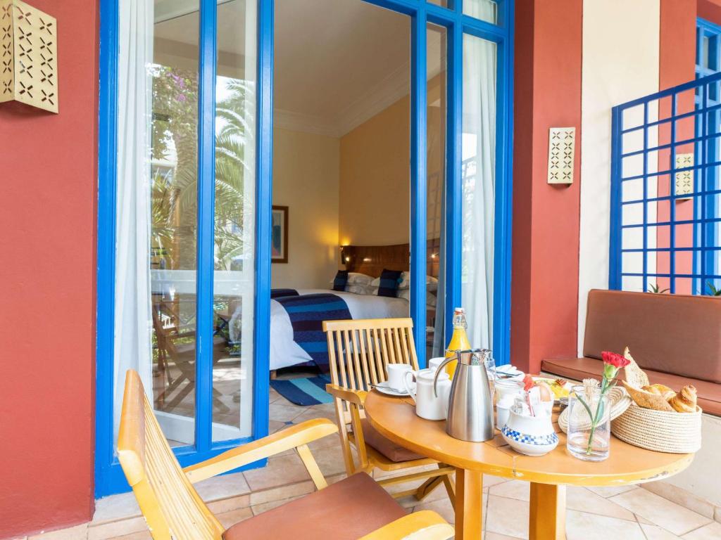 a dining room with a table and chairs at Le Médina Essaouira Thalassa Sea & Spa - MGallery Collection in Essaouira