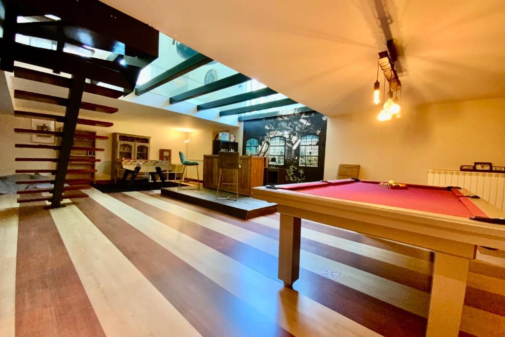 a pool table in the middle of a room at La Moderne- Swimming pool games room and air conditioning! in Saint-Gély-du-Fesc