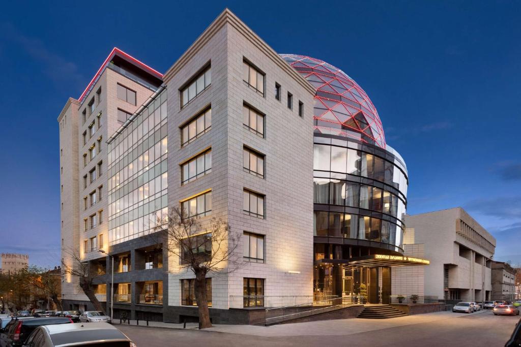 a building with a dome on the side of it at Wyndham Grand Tbilisi in Tbilisi City