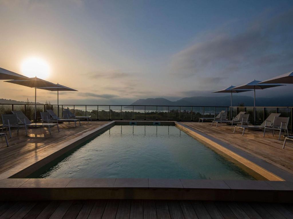 a swimming pool on the roof of a building at ibis Styles Porto Vecchio in Porto-Vecchio