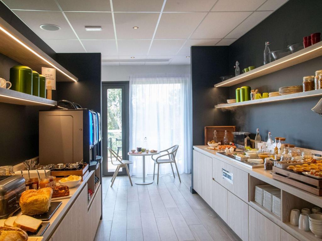 a kitchen with a lot of food on the counters at ibis Styles Porto Vecchio in Porto-Vecchio