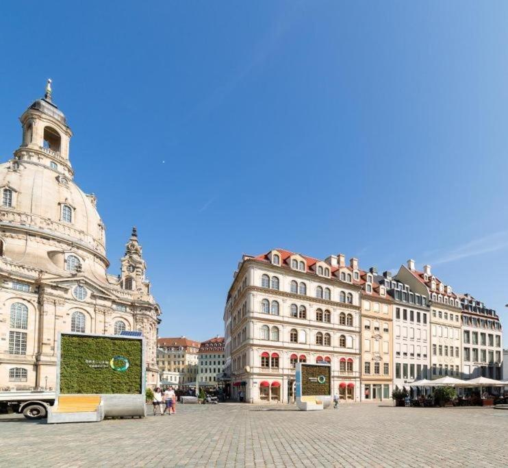 a group of buildings in a square in a city at Aparthotel Neumarkt in Dresden