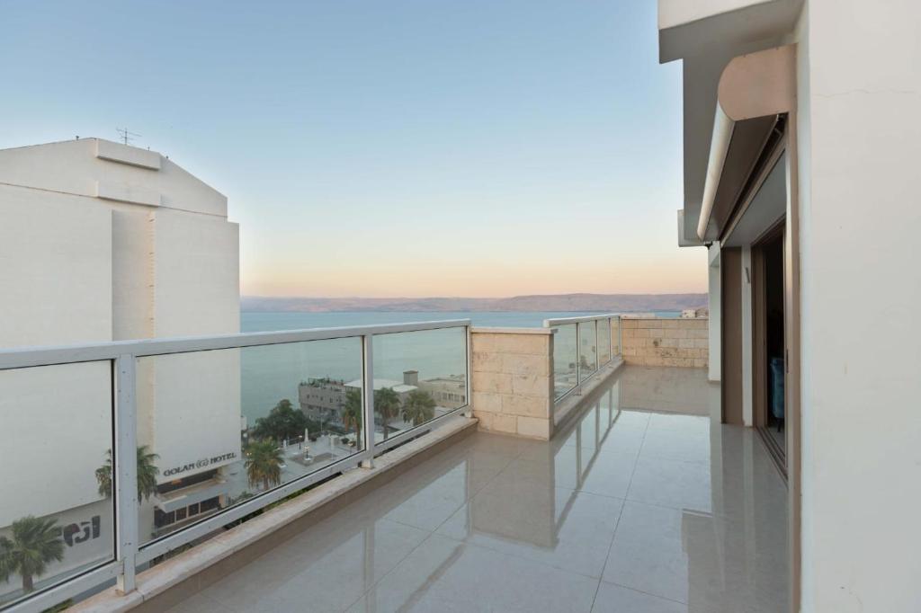 a balcony of a building with a view of the ocean at וילה מפוארת על הכינרת in Tiberias