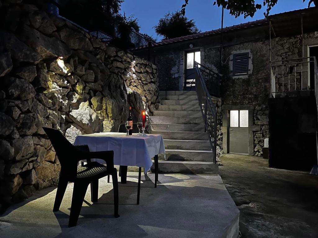 a table in front of a stone building at Lakeview Apartments Jolicic in Virpazar