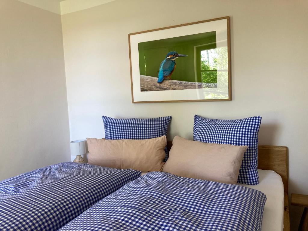 een slaapkamer met twee bedden en een foto van een vogel bij Teichland Linum Apartments in Fehrbellin