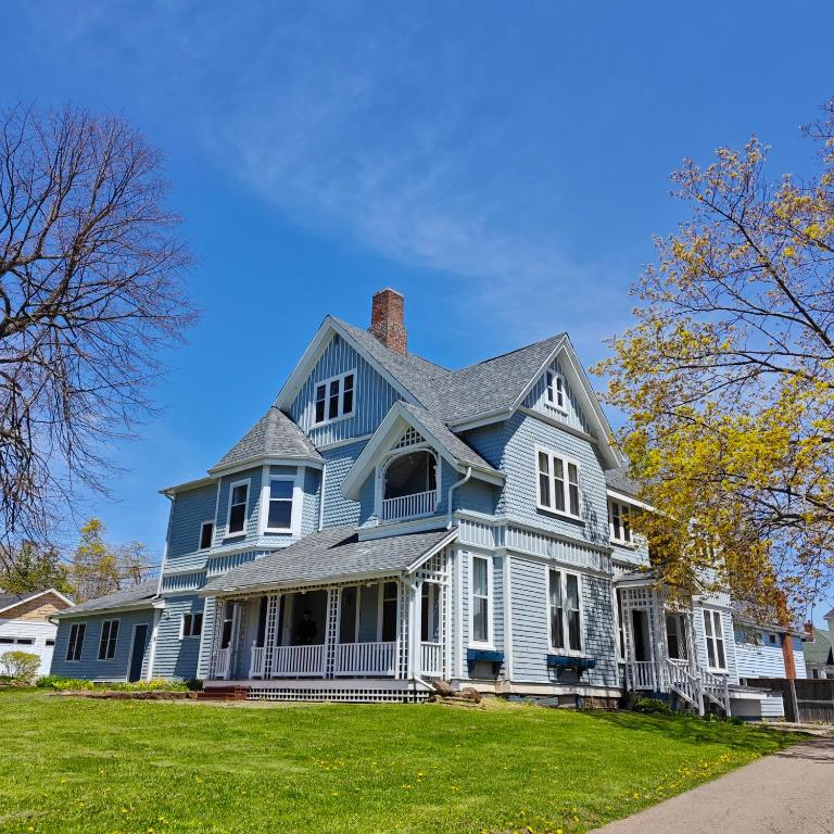 a large blue house with a chimney on top at Andy's Blue House in Charlottetown