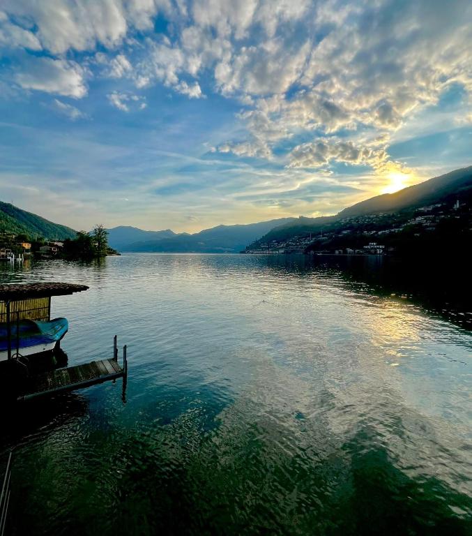 a view of a lake with a dock on the water at Casa Dora in Brusino Arsizio