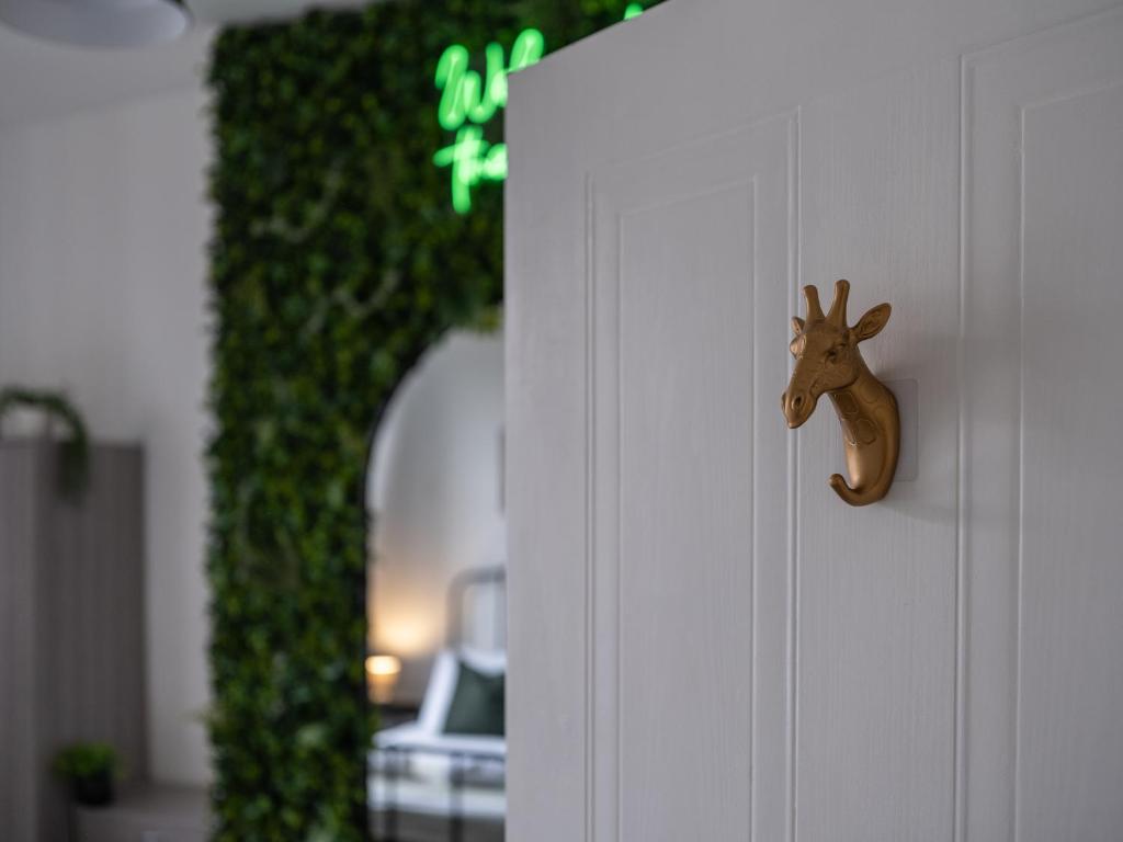 a door knob of a door with a deer head on it at Large Group Central Apartment in Newcastle upon Tyne