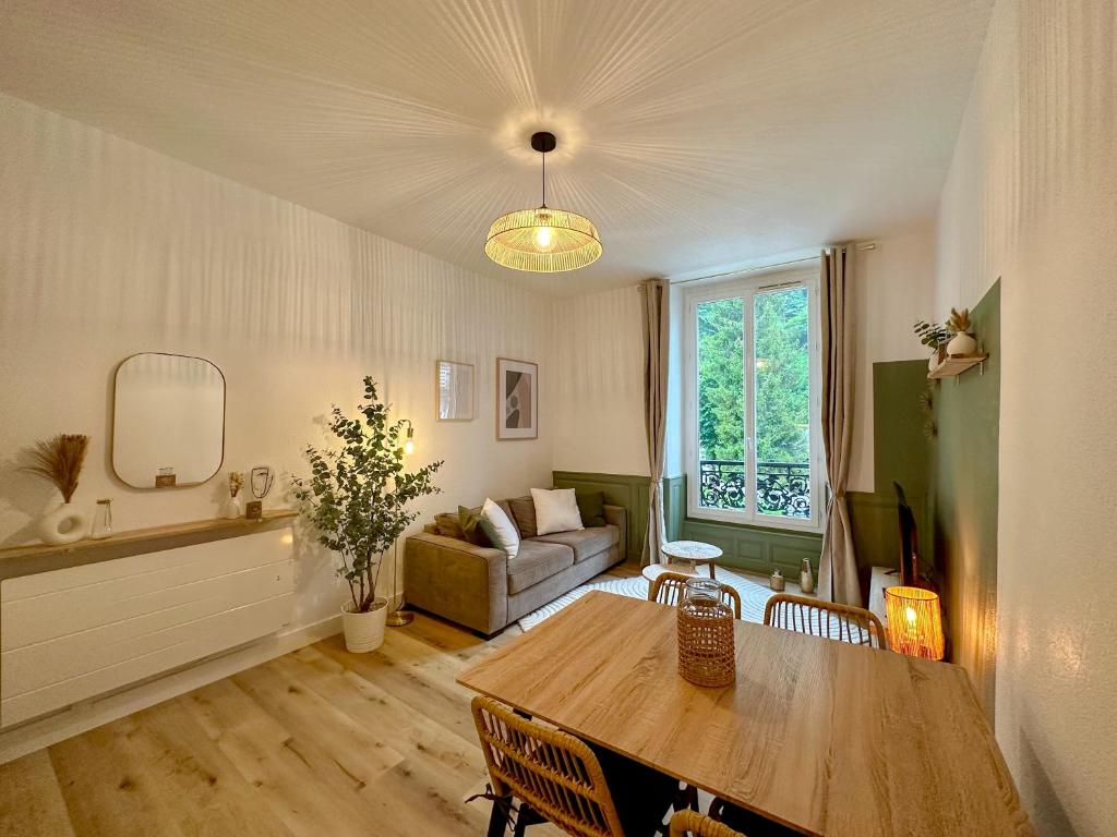 Appartement T2 Eaux-Bonnes في أو-بون: غرفة معيشة مع طاولة وأريكة