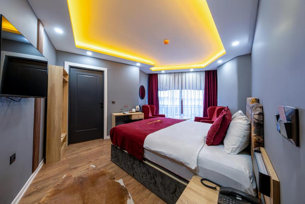 a bedroom with a bed and a flat screen tv at Viv City Hotel in Istanbul