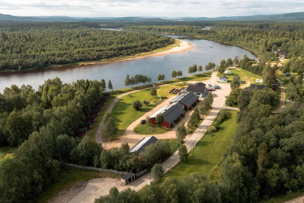 an aerial view of a river with a house at Arctic River Resort in Ivalo