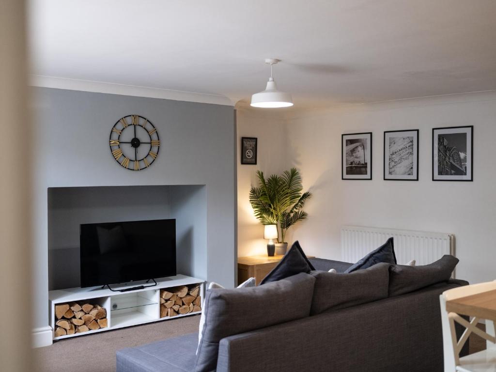 a living room with a couch and a tv at Spacious City Sanctuary in Newcastle upon Tyne
