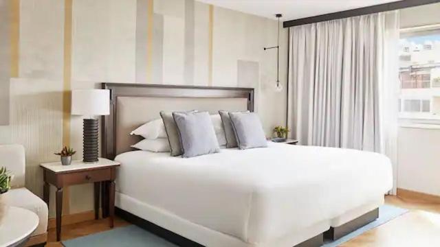 a bedroom with a large white bed and a window at Hyatt Regency Hesperia Madrid in Madrid