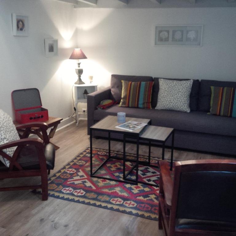 un salon avec un canapé et une table basse dans l'établissement Le Malraux, à Sarlat-la-Canéda