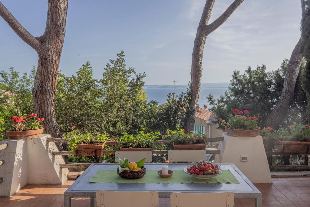 a table with fruits and vegetables on a patio at La Bruna in Porto Santo Stefano