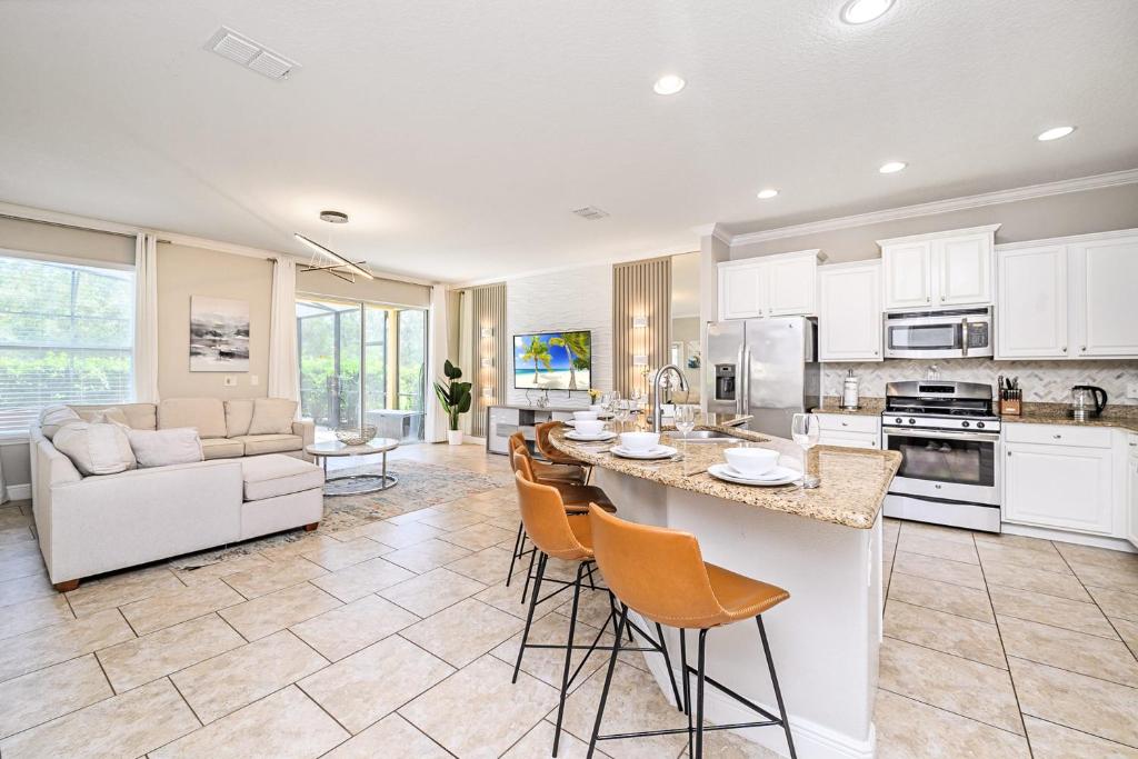 a kitchen and living room with a table and chairs at Solterra Resort Home - Waterslide and Lazy River in Davenport