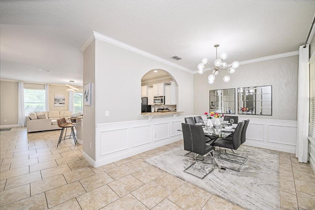 a dining room and living room with a table and chairs at Solterra Resort Home - Waterslide and Lazy River in Davenport