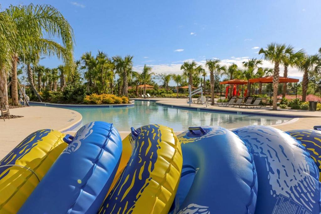 a group of inflatable slides in a pool at a resort at Solterra Resort Home - Waterslide and Lazy River in Davenport
