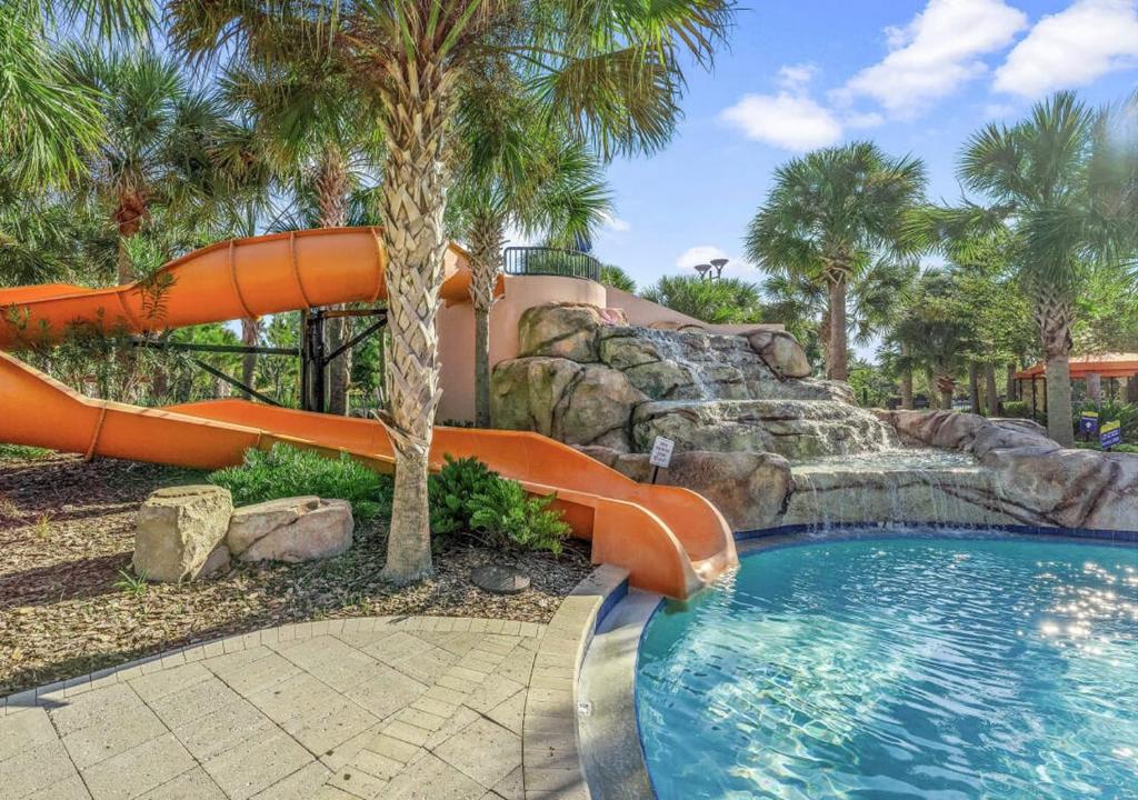 a water slide in a resort with a swimming pool at Solterra Resort Home - Waterslide and Lazy River in Davenport
