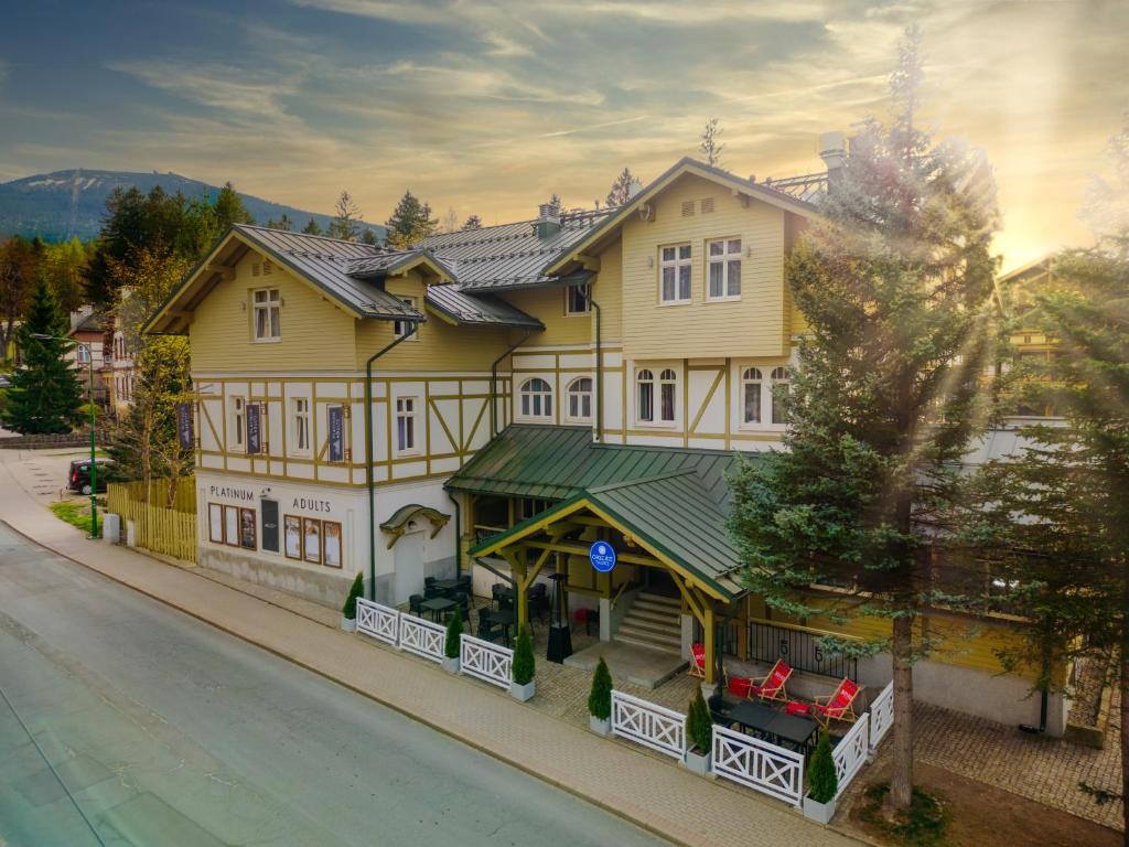 ein großes gelbes Gebäude an der Straßenseite in der Unterkunft Platinum Adults in Szklarska Poręba