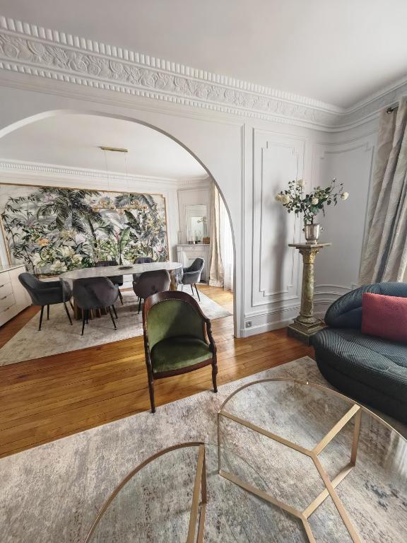 un salon avec un canapé et une table dans l'établissement Grand Appartement Paris 16ème, à Paris