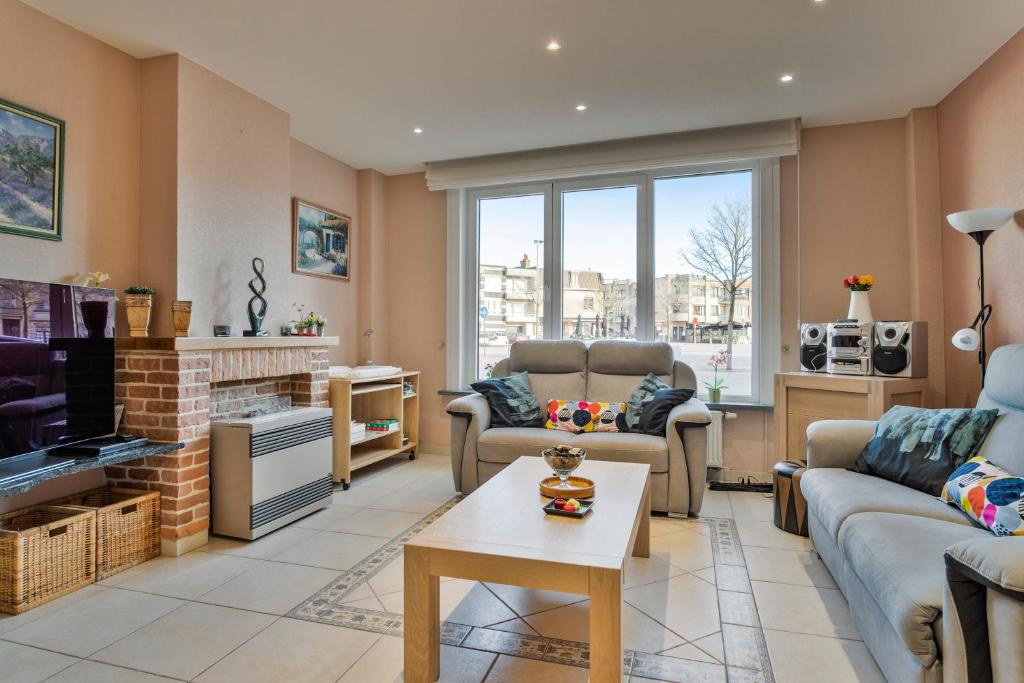 a living room with a couch and a tv at Markt 28 Glvls in Wenduine