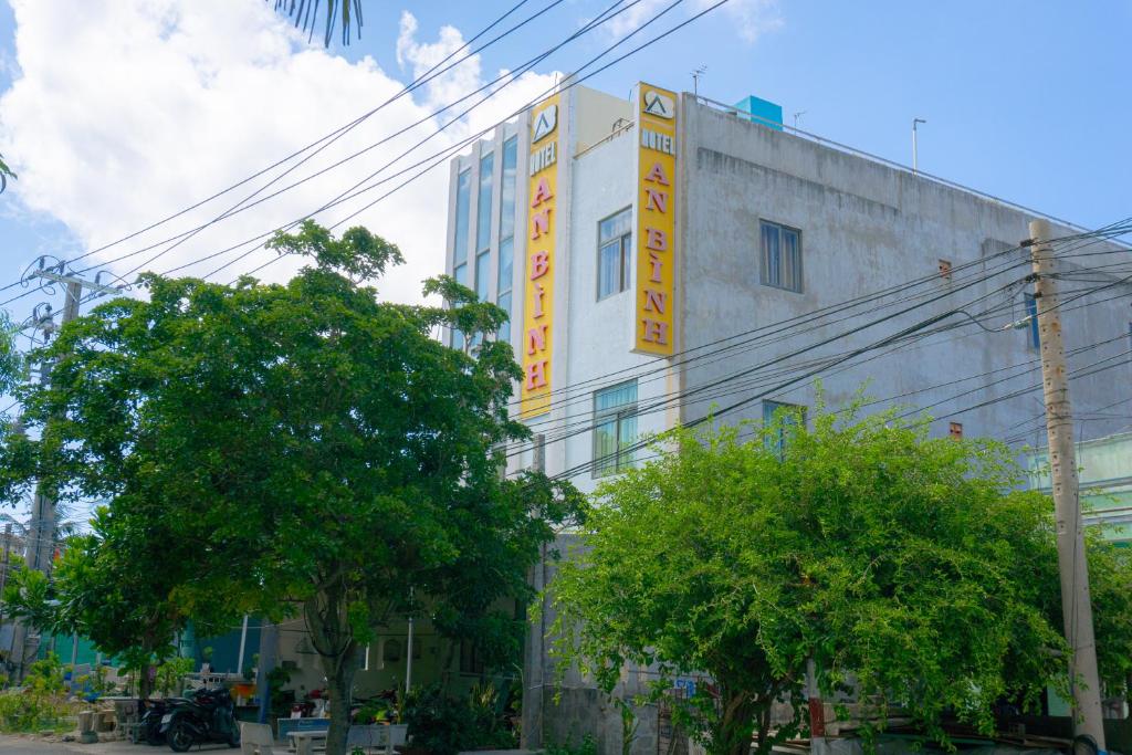 a building with a sign on the side of it at Khách Sạn An Bình Đảo Phú Quý in Phú Quý