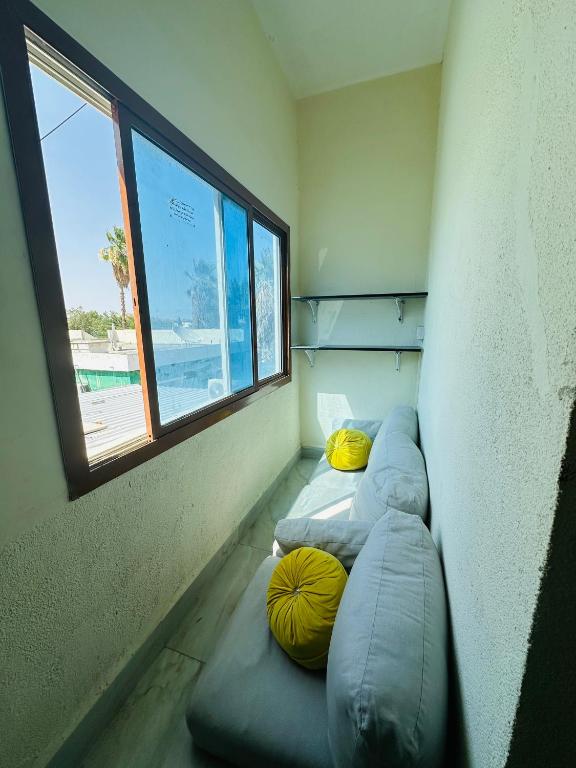 a room with three bean bags and a window at AM a shared room in Doha
