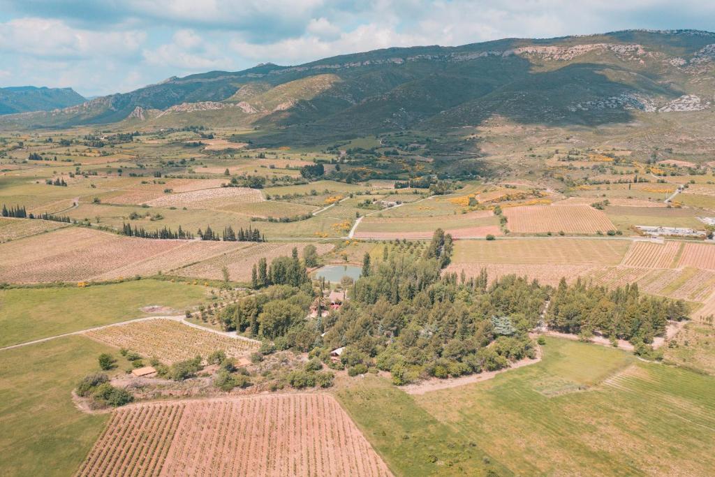 an aerial view of a field with trees and mountains at Tente évasion in Tuchan