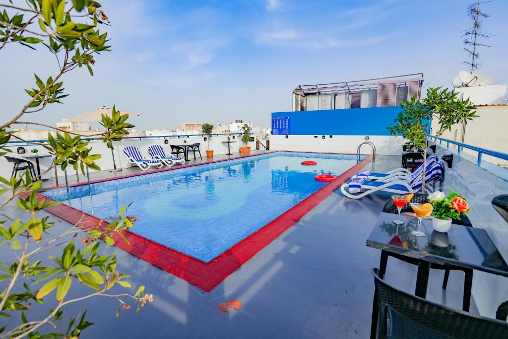 a swimming pool on the roof of a building at Fortune Pearl Hotel in Dubai