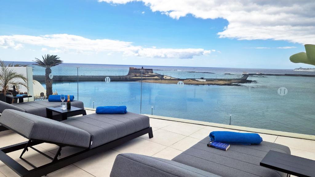 a living room with a view of the ocean at Blue Marina Suites - Boutique Apartments in Arrecife