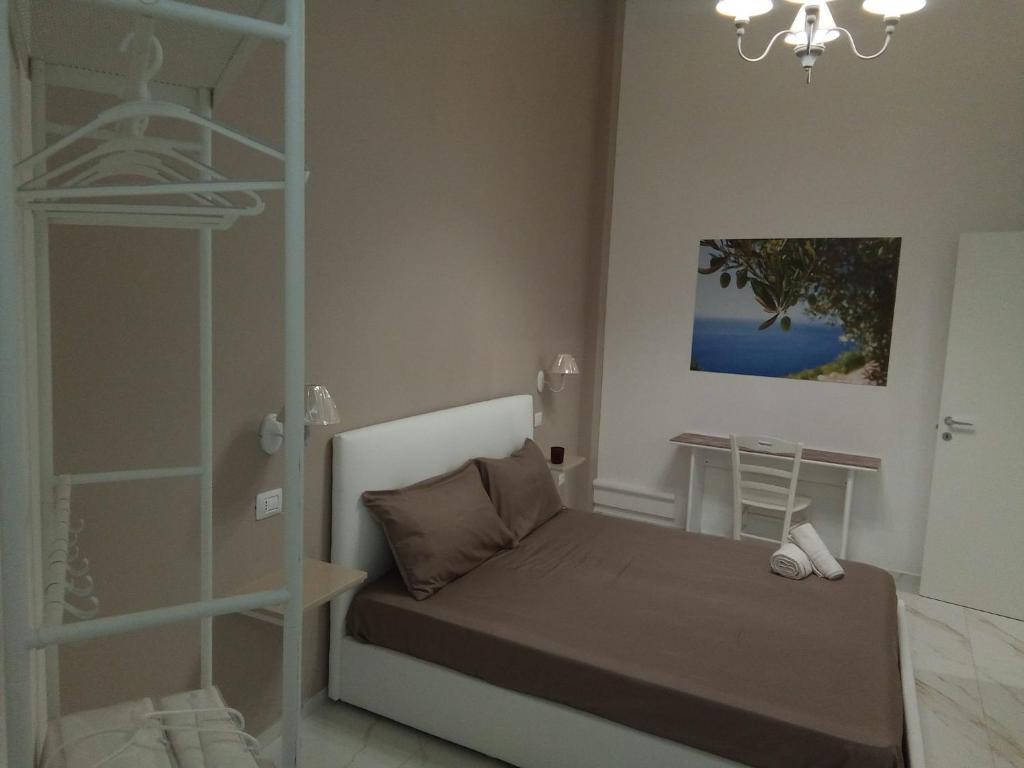 a small bedroom with a bed and a shelf at Angela's dreams in Conversano