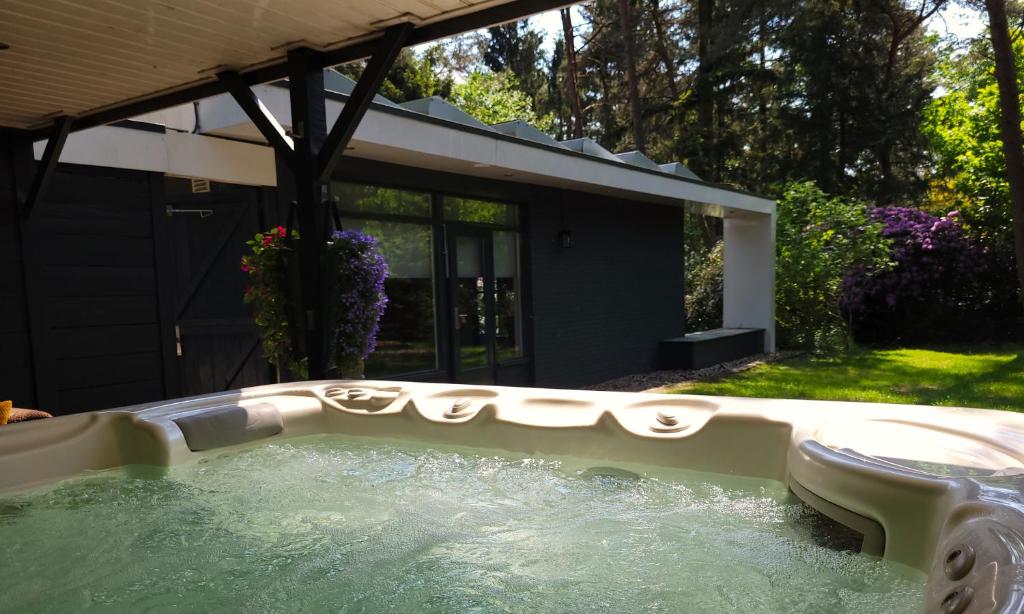 een hot tub in de achtertuin van een huis bij Secret Wellness Puur Natuur in Holten