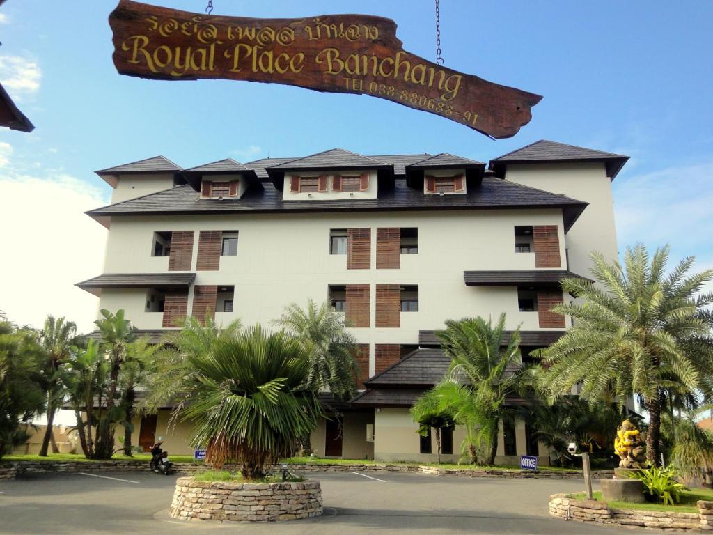 a hotel with a sign in front of a building at Royal Place Banchang in Ban Chang