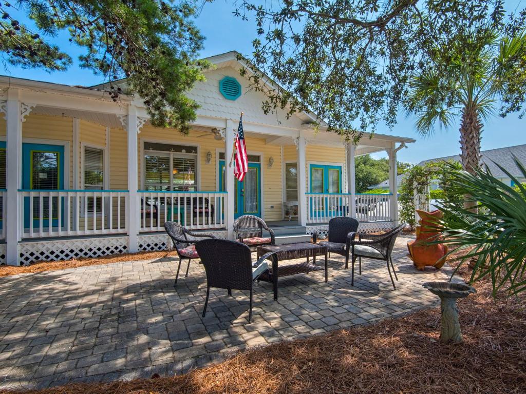 a house with chairs and a table on a patio at Caribbean Breeze by Newman-Dailey in Destin