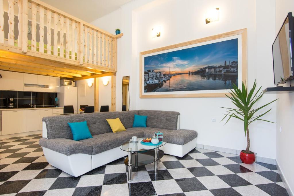 a living room with a couch and a table at Apartments Storia in Trogir