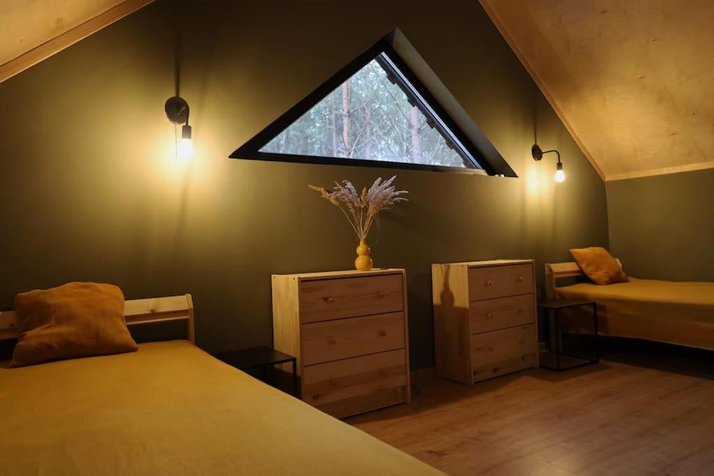 a bedroom with a window and a bed and a dresser at Domek SzumiSosna1 in Raków