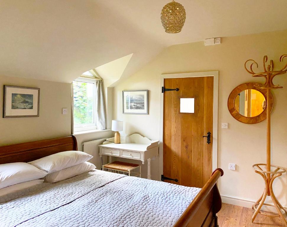 a bedroom with a bed and a window and a desk at Close to Snowdon with Mountain views of Snowdonia in Caernarfon