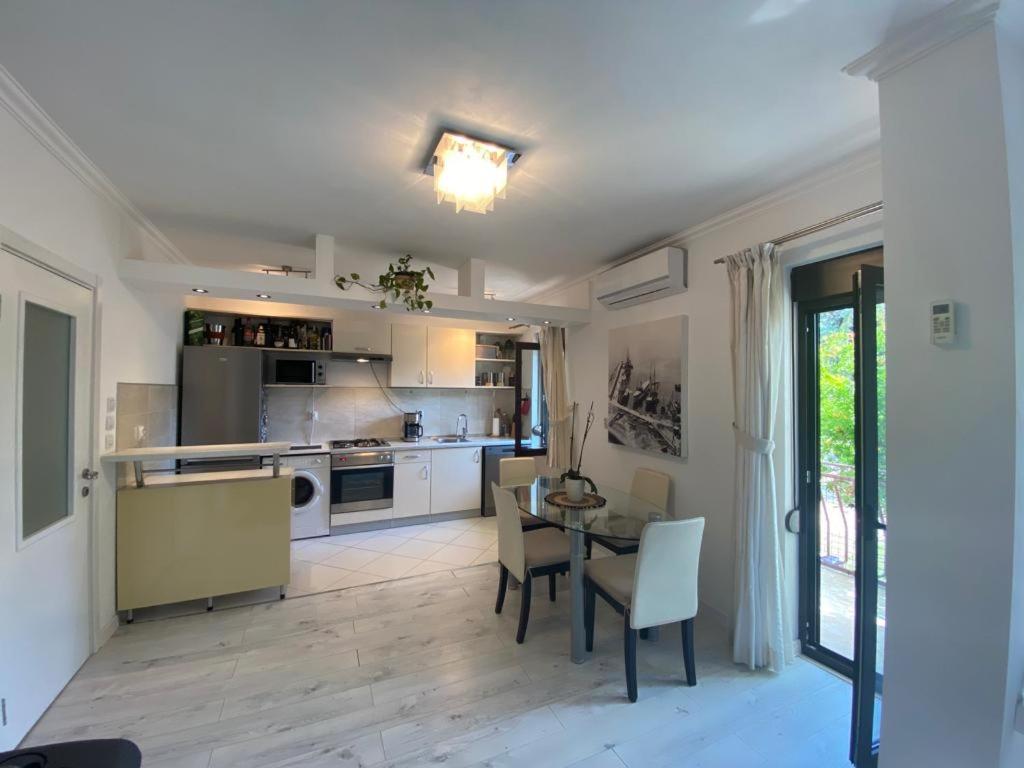 a kitchen and dining room with a table and chairs at Fis~her~man`s Apartment in Herceg-Novi