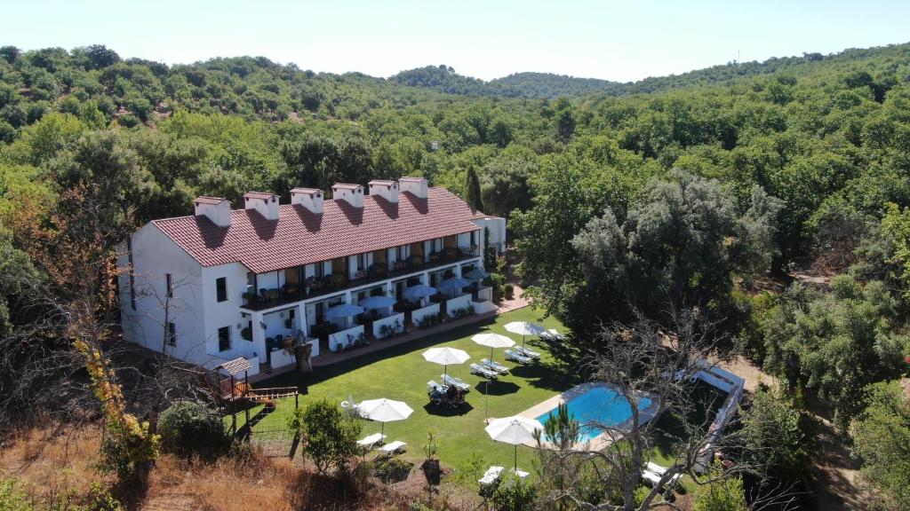 an aerial view of a mansion in the woods at Hotel Apartamento Rural Finca La Media Legua in Aracena