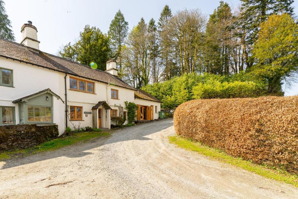 a dirt road in front of a white house at Old Farmhouse in Hawkshead