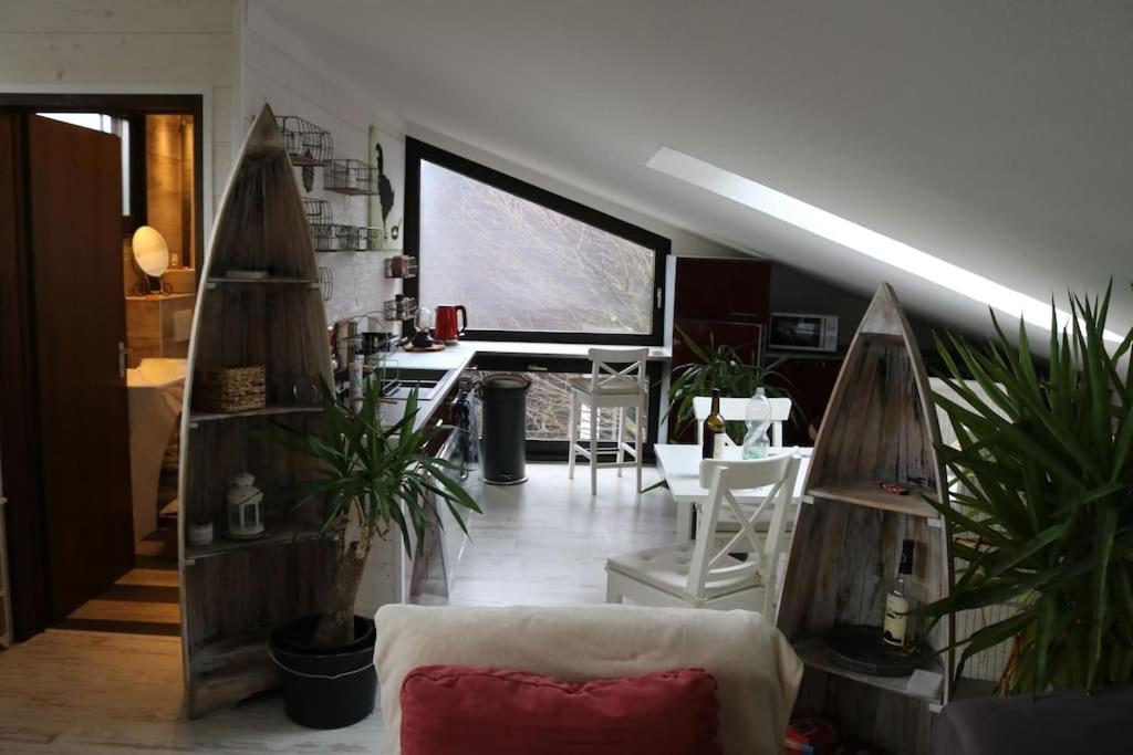 a living room with a couch and some plants at Schönes Loft 2 Personen 1-Raum 60qm in Meschede