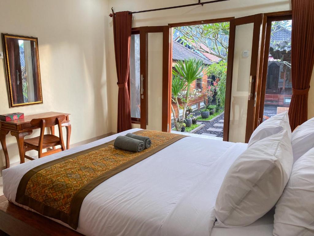Postel nebo postele na pokoji v ubytování Bojig House Ubud