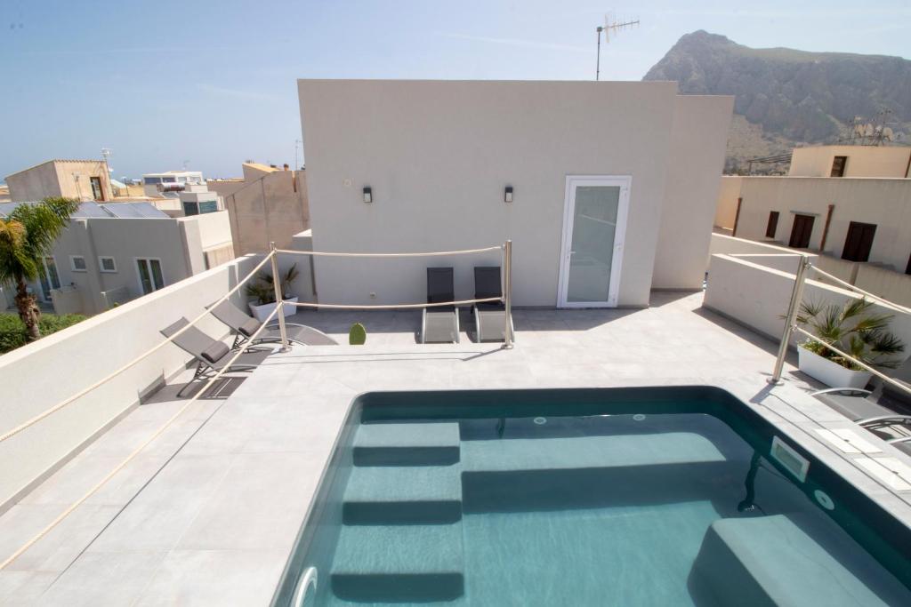 a swimming pool on the roof of a house at Hotel Arte Mare in San Vito lo Capo