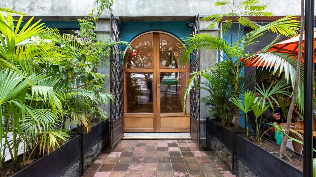 a front door of a building with plants at Soy Local Primavera in Medellín